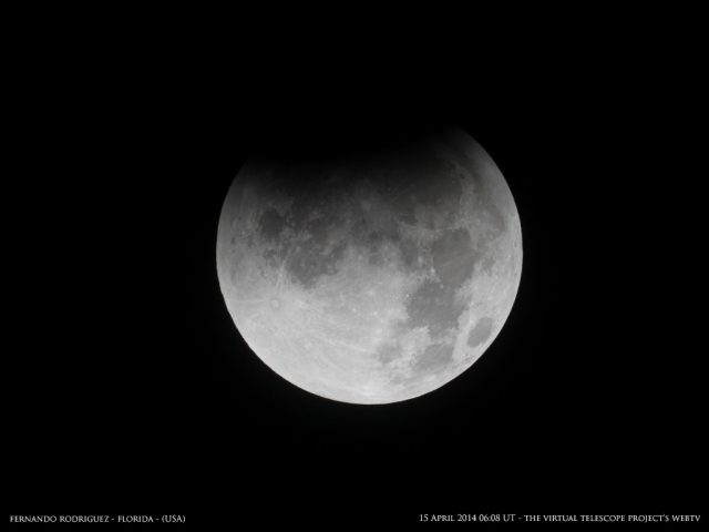 Finally, the umbra started covering the Moon. Image by Fernando Rodriguez, shared live via The Virtual Telescope Project