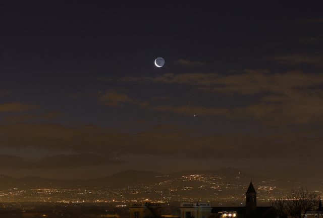 A sharp crescent Moon, Venus and Mercury are hanging above the Roman Castles, as seen from Gianicolo, in Rome. 6 Feb. 2016