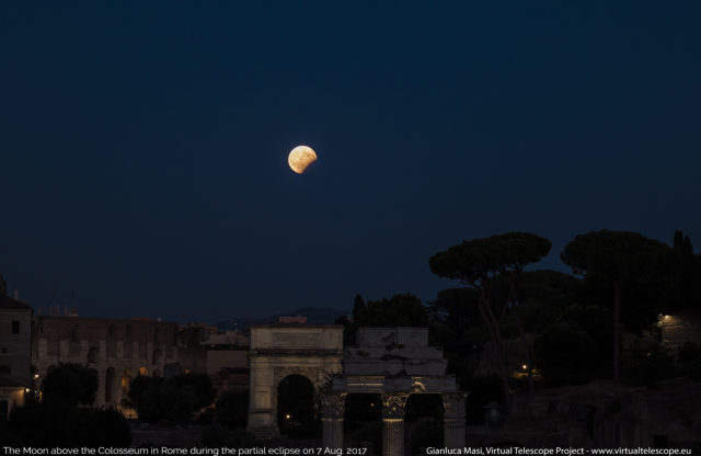 Later in the evening, the eclipsed Moon hangs above the Colosseum and the Titus' Arch. 07 Aug. 2017, 18:42 UT