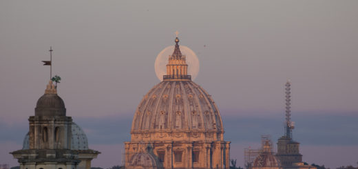 The Supermoon is perfectly behind the lantern of the St. Peter's Dome, shining in the first light of the new day