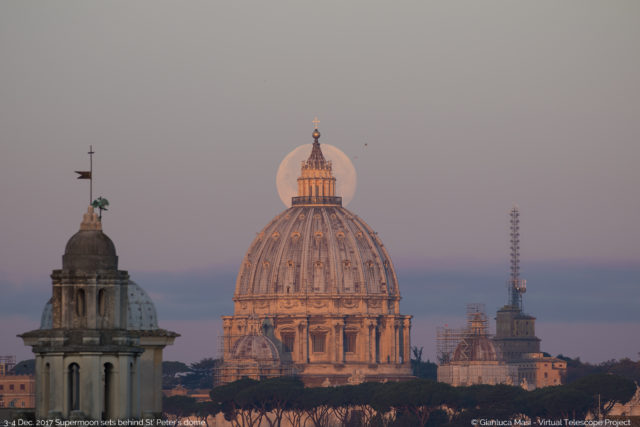 The Supermoon is perfectly behind the lantern of the St. Peter's Dome, shining in the first light of the new day