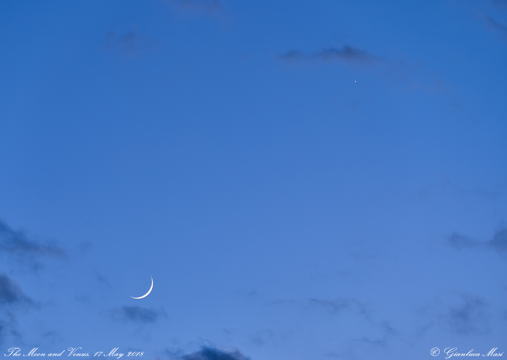 Soon after the sunset, the Moon and Venus appear among gentle clouds