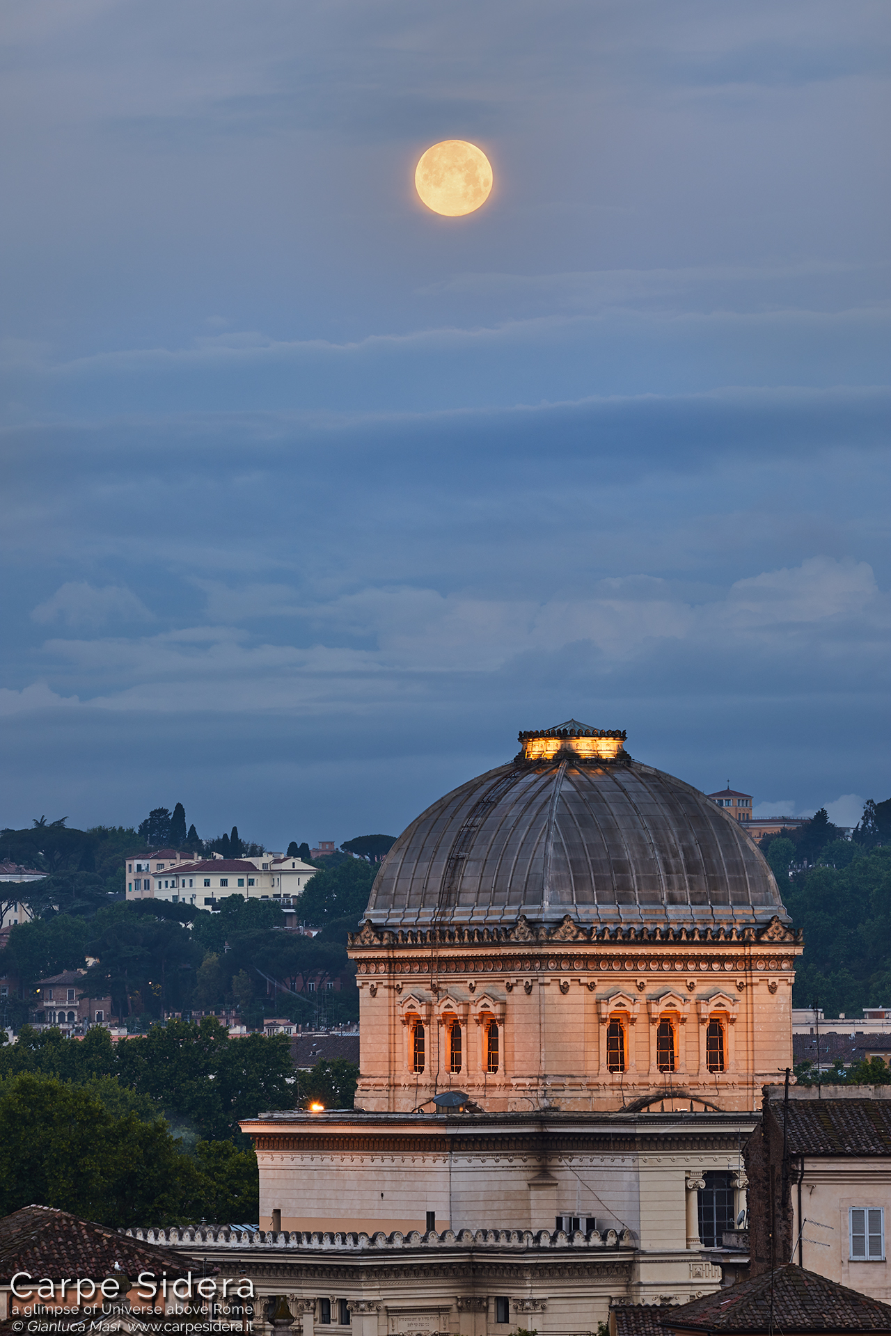 The May 2019 "Blue Moon" is ready to set and hangs above the Great Synagogue of Rome