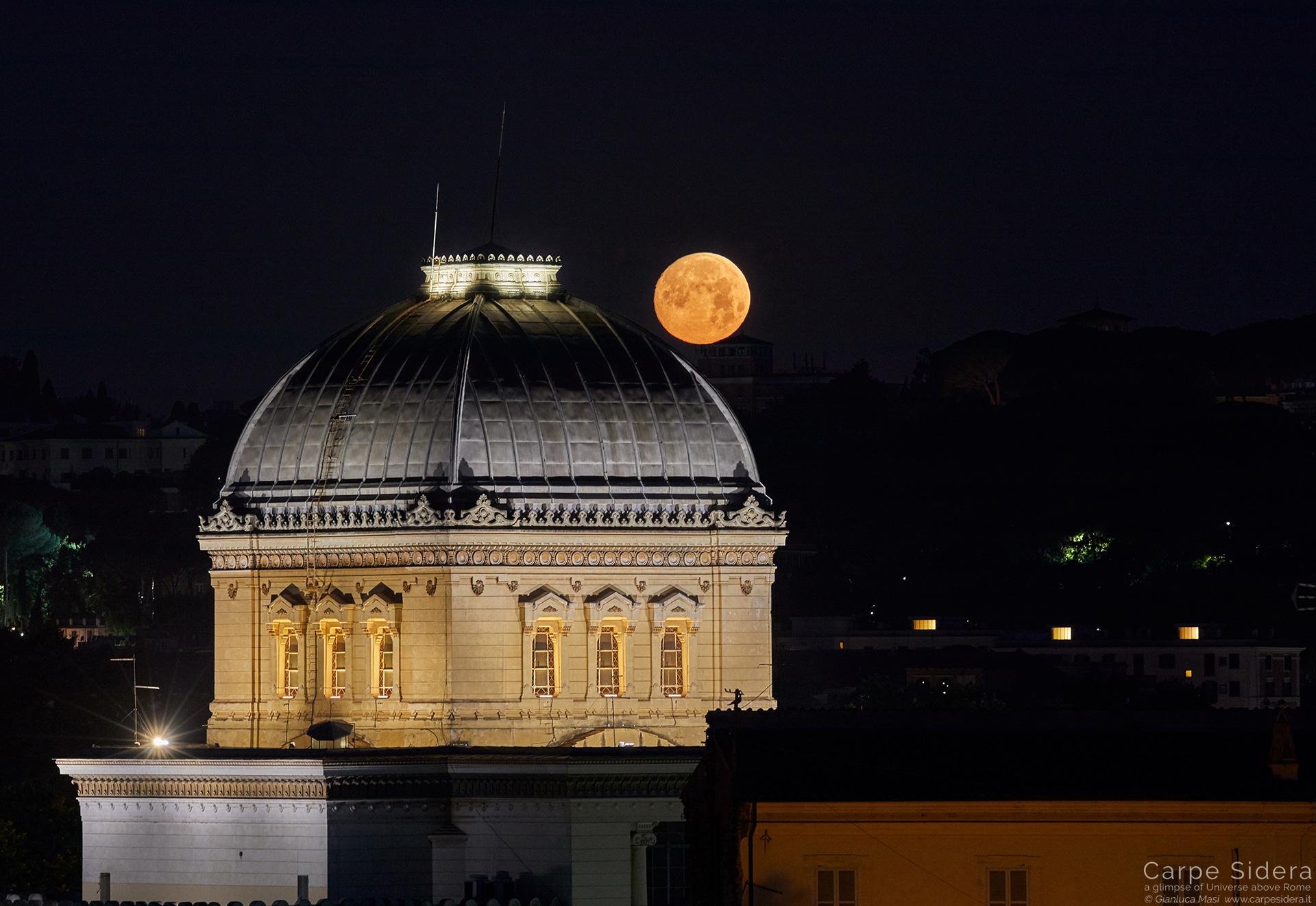 On 16 June 2019, an almost full Moon set in a still dark sky behind the Synagogue of Rome -16 June 2019
