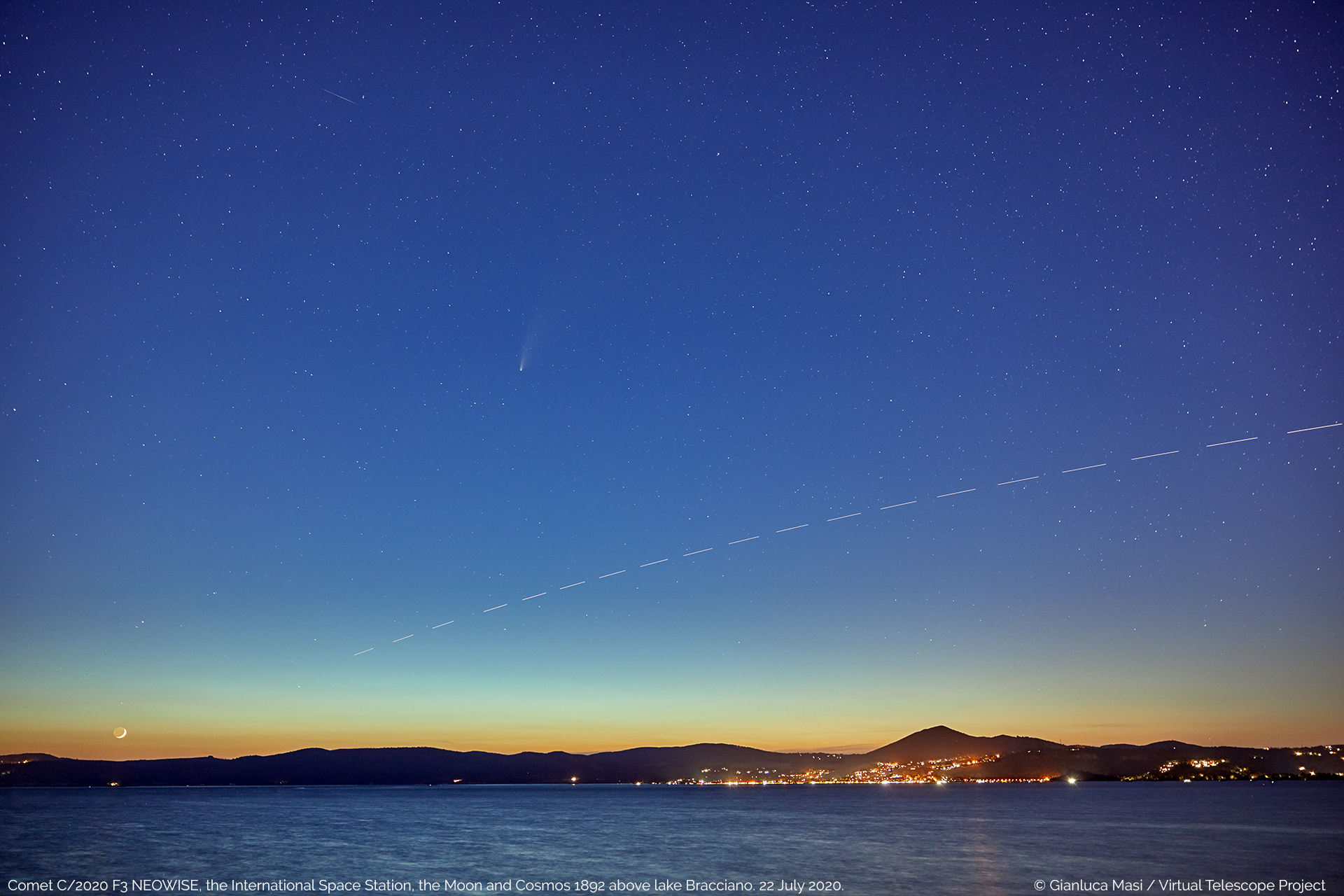 Comet C/2020 F3 NEOWISE at sunset, above the lake Bracciano, Italy, with a very young Moon and the International Space Station crossing the field of view, as well as satellite Cosmos 1892 - 22 July 2020.