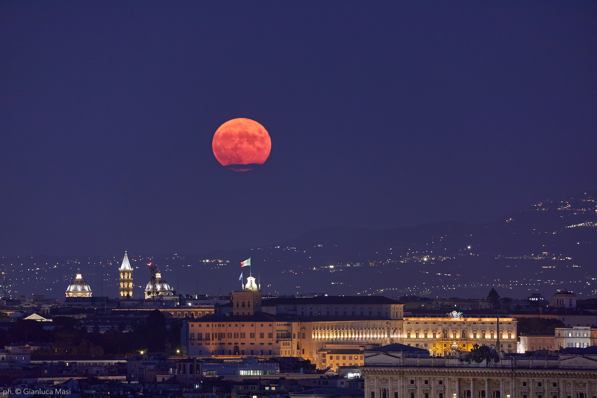 The Aug. 2021 Full Moon rises above “Palazzo del Quirinale”, in Rome.