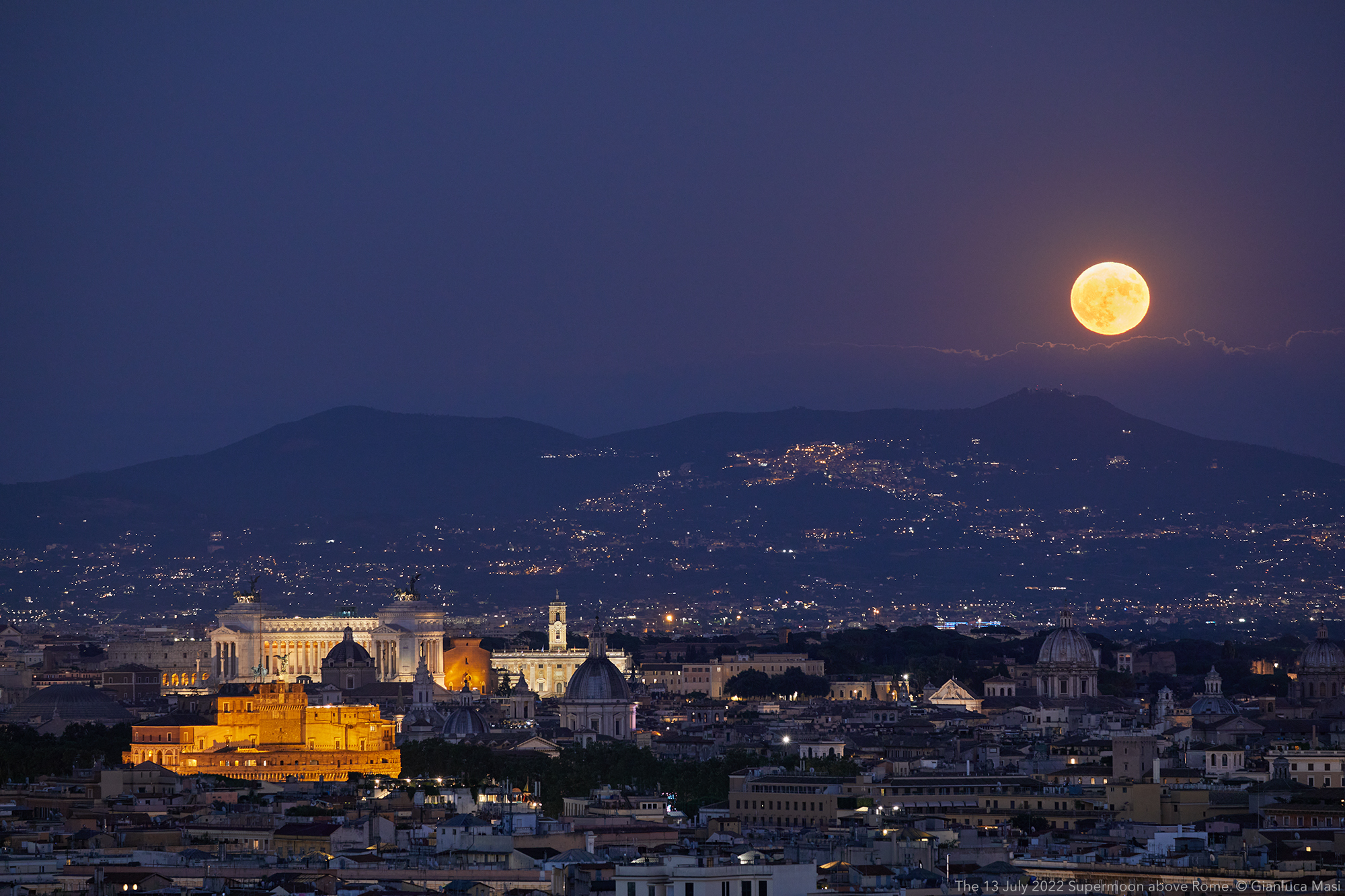 The July 2022 Supermoon shines above Rome at the beginning of the evening.