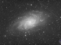 Messier 33, with a couple of satellite trails.